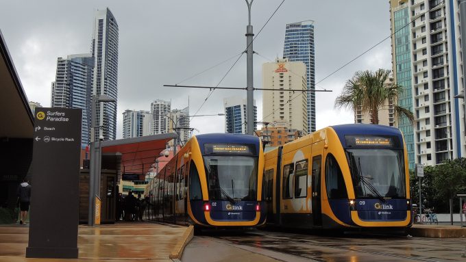 two gold coast light rail trains at a station