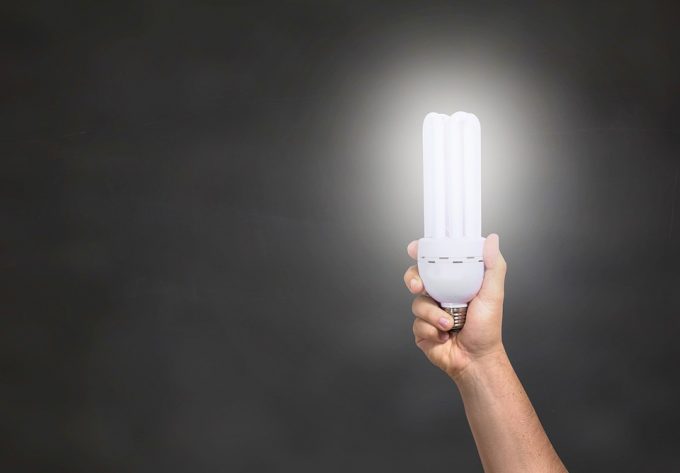 a hand holding an LED lightbulb