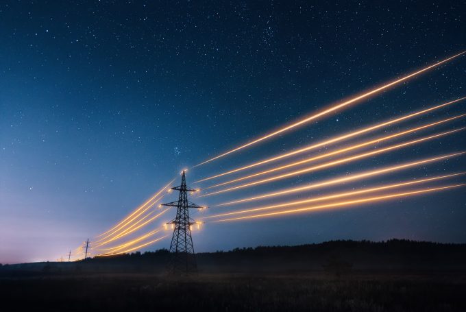 Electricity,Transmission,Towers,With,Orange,Glowing,Wires,The,Starry,Night