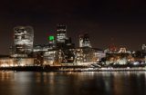 london skyline at night taken from the south bank near tower bridge