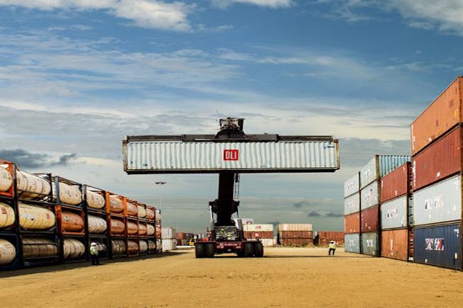 a shipping container branded dli being held aloft in a logistics facility 230907 iip dli