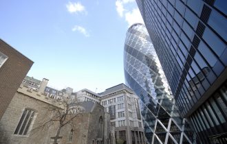 view of the Gherkin flanked by St Helen's church and modern office building