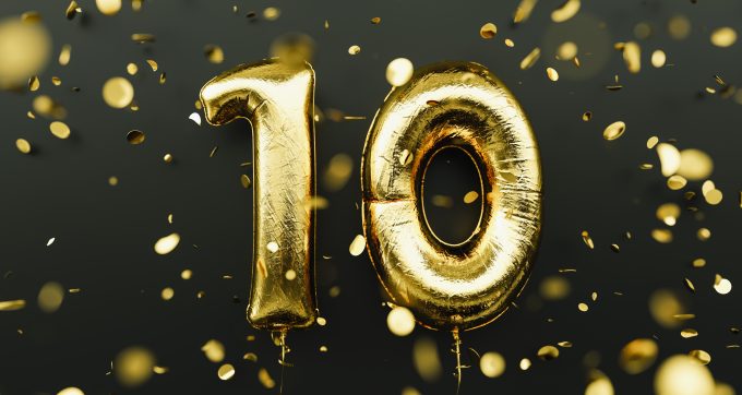 good ballons spell out 10 and gold confetti fills the picture against a black background