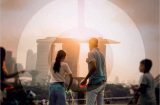 blurry view of a family in a park with Singapore's Marina Bay Sands hotel in the distance