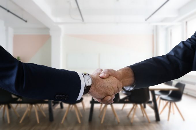 handshake in a boardroom