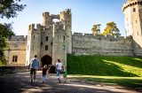 A family of four walking into the gate of LXI's Warwick Castle