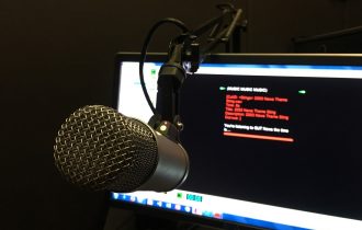 a radio microphone in front of a blurred screen