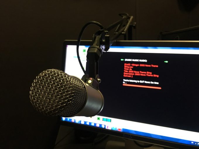 a radio microphone in front of a blurred screen