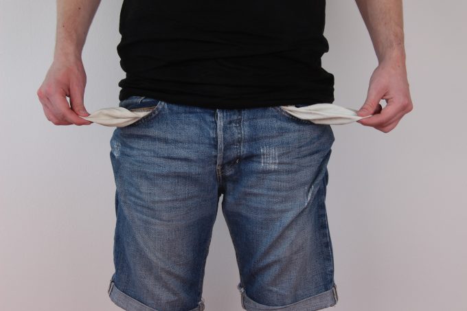 a man in jeans showing he has empty pockets