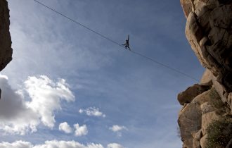 a tightrope walker crossing a gorge