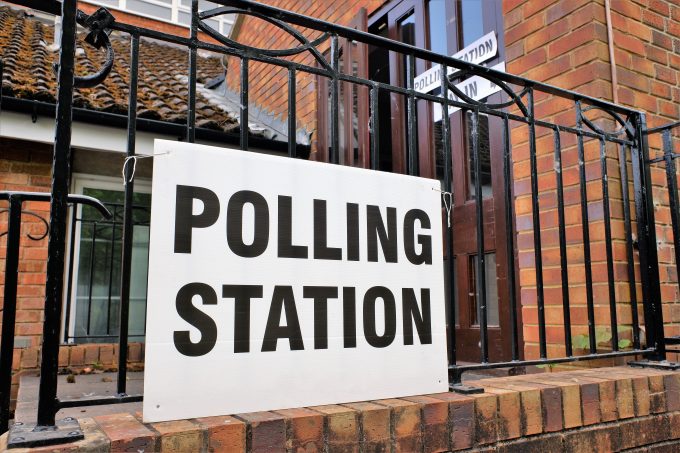 polling station sign attached to some railings