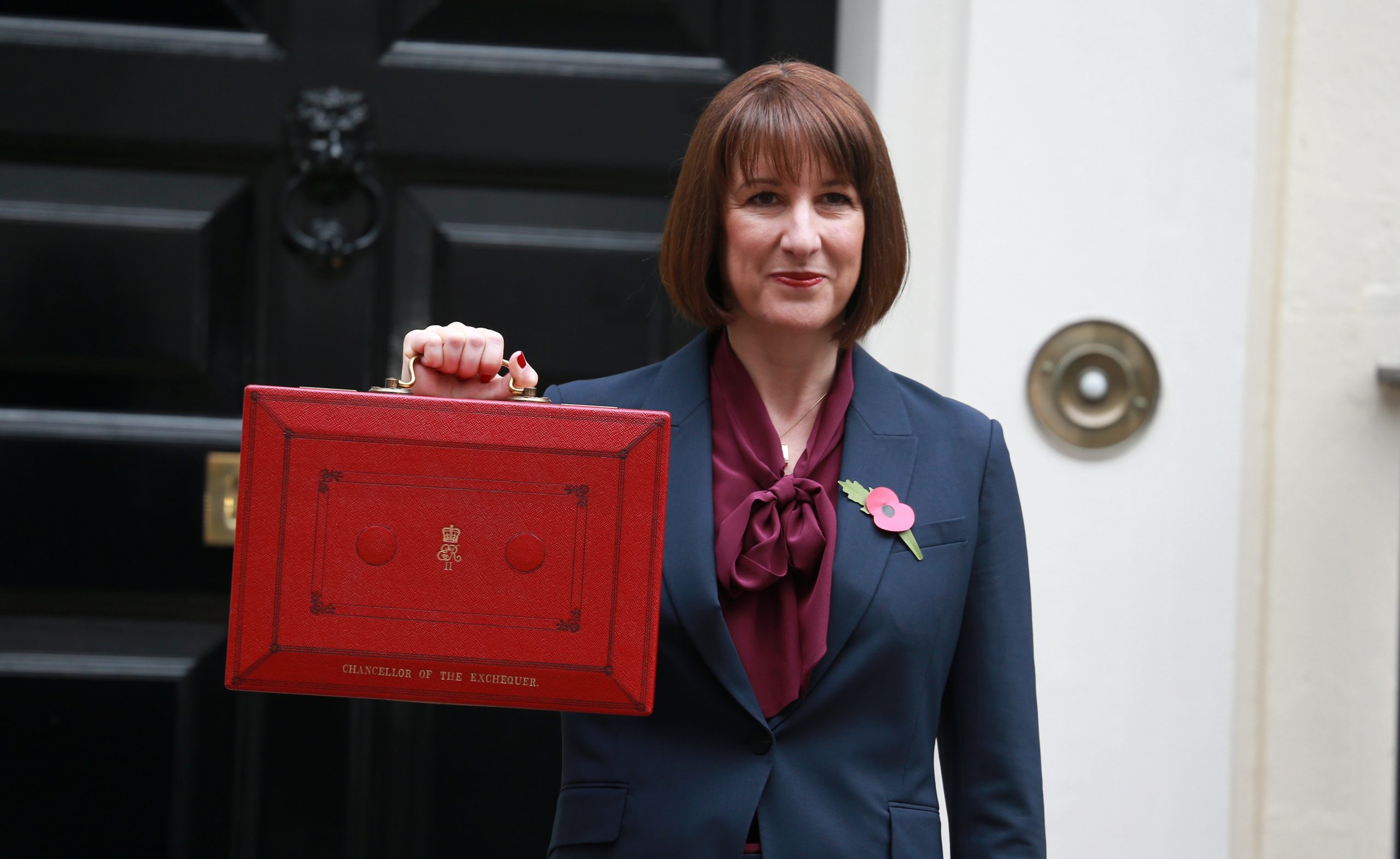 Chancellor rachel reeves holding up ministerial red case containing budget
