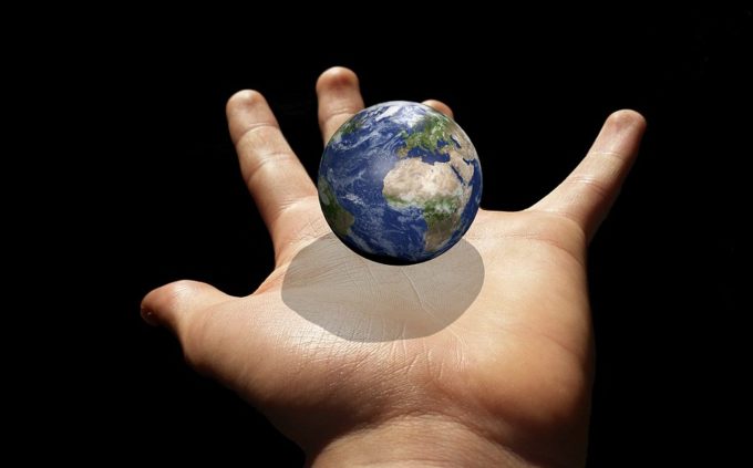 an image of Earth in the palm of a hand