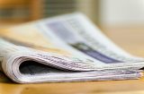a folded newspaper, image slightly blurred