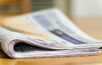 a folded newspaper, image slightly blurred