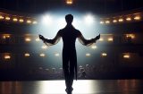 view from behind of a performer looking out at an audience