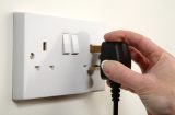 a plug about to be plugged into a socket