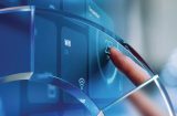 a finger adjusting a temperature control on a blue digital touch screen