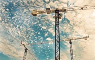 yellow construction cranes viewed from below