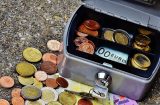a cash box with euro coins and notes underneath