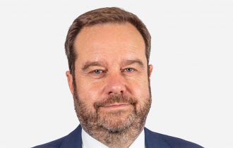 a head shot of Nick Greenwood
