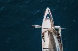 an aerial shot of the front of a racing yacht at sea