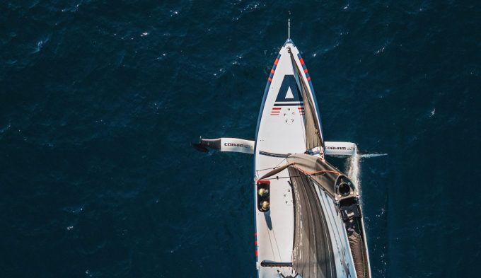 an aerial shot of the front of a racing yacht at sea