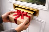 Present being delivered in a brass letterbox