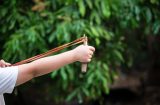 a child stretches a catapult