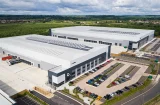 an aerial shot of lmp's beford logistics park - couple of sheds and a car park