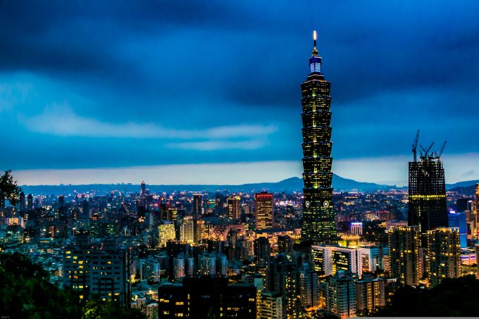 a view at dusk of taipei with the taipei 101 tower in the middle