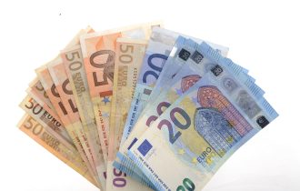 euro notes fanned out on a white background