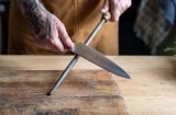 a man sharpening a kitchen knife